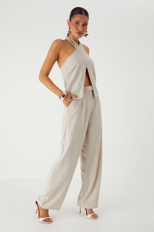 Tailored wide leg design for a dramatic silhouette that commands attention
        Practical side pockets perfect for stashing your essentials on a night out
        High-rise waistband to flatter your figure and provide comfortable all-day wear
        Smooth twill fabric that drapes beautifully with movement
        Versatile design that transitions effortlessly from day to evening events
    
    Make a statement in these MissPap Twill Wide Leg Tailored Trousers, designed to turn heads wherever you go. The dramatic wide leg cut creates a bold silhouette that flows gracefully with every step, whilst the high-rise waistband accentuates your waist for a figure-flattering effect. Style with a cross-halter top as shown for a night on the town, or dress down with a fitted tee and trainers for daytime chic. These trousers work brilliantly for family gatherings when paired with a soft blouse and flat sandals, or amp up the drama for evening drinks with strappy heels and statement jewellery. The side pockets add practical functionality to this fashion-forward piece, making these trousers the perfect addition to your wardrobe for those who want to showcase their confident style whilst maintaining comfort.