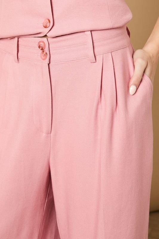 Tailored wide leg design with elegant front pleats for a flattering silhouette
        High-rise waistband with button fastening for a secure and comfortable fit
        Practical side pockets perfect for everyday essentials
        Flowing wide leg cut creates a graceful drape when walking
        Versatile woven fabric suitable for both formal occasions and smart-casual styling
    
    These sophisticated wide leg trousers from Oasis present the perfect balance of comfort and elegance. The tailored design features a flattering high waist that creates a sleek silhouette, whilst the generous wide leg cut offers a contemporary twist on classic formal wear. Style with the coordinating waistcoat for a chic two-piece ensemble perfect for summer weddings and race day events. For more relaxed occasions, pair with a simple silk camisole and metallic sandals as shown. The clean lines and structured fabric make these trousers an excellent choice for important meetings or graduation ceremonies, whilst their lightweight feel ensures you'll remain comfortable throughout the day. Add statement jewellery and a clutch bag to transform them into an evening-ready outfit that radiates refined femininity.