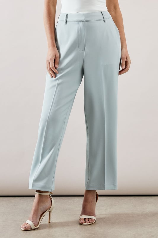 Tapered design creates a flattering silhouette that narrows towards the ankle
        Smooth woven fabric with added stretch for day-long comfort
        Clean front seam detail adds a sophisticated touch
        Side pockets provide practical functionality
        Versatile ankle-length cut perfect for showcasing statement footwear
    
    These elegant tapered trousers from Wallis combine sophistication with everyday comfort. The streamlined silhouette offers a contemporary look whilst maintaining a relaxed feel, making them ideal for various daytime occasions. Style them as shown with a button-detail top for family gatherings or weekend brunches. The ankle-length cut pairs beautifully with strappy sandals during warmer months or with ballet flats and a lightweight jumper for cooler days. For a polished casual look, team with a tucked-in blouse and a structured tote bag. The versatile design transitions effortlessly from office to casual outings, whilst the added stretch ensures comfort throughout the day. These trousers are a wardrobe essential that will complement numerous existing pieces in your collection.