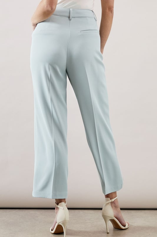 Tapered design creates a flattering silhouette that narrows towards the ankle
        Smooth woven fabric with added stretch for day-long comfort
        Clean front seam detail adds a sophisticated touch
        Side pockets provide practical functionality
        Versatile ankle-length cut perfect for showcasing statement footwear
    
    These elegant tapered trousers from Wallis combine sophistication with everyday comfort. The streamlined silhouette offers a contemporary look whilst maintaining a relaxed feel, making them ideal for various daytime occasions. Style them as shown with a button-detail top for family gatherings or weekend brunches. The ankle-length cut pairs beautifully with strappy sandals during warmer months or with ballet flats and a lightweight jumper for cooler days. For a polished casual look, team with a tucked-in blouse and a structured tote bag. The versatile design transitions effortlessly from office to casual outings, whilst the added stretch ensures comfort throughout the day. These trousers are a wardrobe essential that will complement numerous existing pieces in your collection.