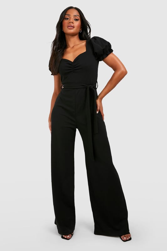 Sweetheart neckline for a feminine touch
        Puff sleeves add a romantic flair
        Tie waist detail for a customisable fit
        Wide leg silhouette for a dramatic look
        Scuba crepe fabric offers structure and comfort
    
    Make a statement in this eye-catching wide leg jumpsuit, perfect for those nights out when you want to turn heads. The puff sleeves and sweetheart neckline create a romantic silhouette, while the tie waist allows you to accentuate your figure. The wide leg design adds drama and movement, ideal for dancing the night away. Style it with strappy heels and a clutch bag for a chic club ensemble, or dress it down with trainers and a denim jacket for a more casual drinks outing. The versatile nature of this jumpsuit makes it a go-to piece for various social occasions, from bar hopping with friends to a night of urban exploration. Its blend of comfort and style ensures you'll feel confident and fashionable throughout your evening adventures.