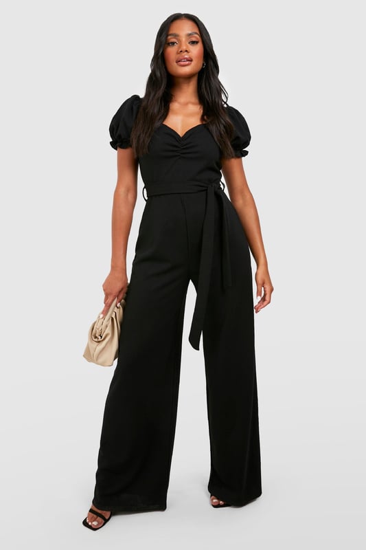 Sweetheart neckline for a feminine touch
        Puff sleeves add a romantic flair
        Tie waist detail for a customisable fit
        Wide leg silhouette for a dramatic look
        Scuba crepe fabric offers structure and comfort
    
    Make a statement in this eye-catching wide leg jumpsuit, perfect for those nights out when you want to turn heads. The puff sleeves and sweetheart neckline create a romantic silhouette, while the tie waist allows you to accentuate your figure. The wide leg design adds drama and movement, ideal for dancing the night away. Style it with strappy heels and a clutch bag for a chic club ensemble, or dress it down with trainers and a denim jacket for a more casual drinks outing. The versatile nature of this jumpsuit makes it a go-to piece for various social occasions, from bar hopping with friends to a night of urban exploration. Its blend of comfort and style ensures you'll feel confident and fashionable throughout your evening adventures.