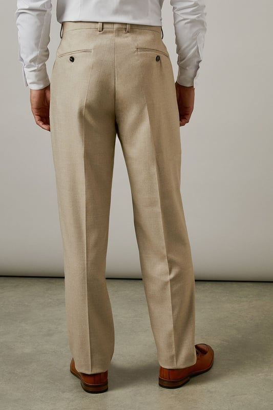 Slim fit design with a tailored silhouette that defines the leg without restricting movement
        Textured woven fabric adds subtle dimension and visual interest to your formal attire
        Classic flat front styling for a clean, contemporary appearance
        Functional side pockets and button-fastened back pockets for practicality
        Versatile neutral tone that pairs effortlessly with various shirt and jacket combinations
    
    These textured slim fit trousers from Burton deliver refined style with modern sensibility. The tailored cut creates a sharp silhouette that's ideal for the gentleman who appreciates classic styling with contemporary proportions. Perfect for work-to-weekend versatility, pair them with the matching jacket for formal occasions or team with a crisp white shirt as shown for smart-casual events. The textured fabric adds character whilst maintaining a sophisticated appearance that works brilliantly for important meetings or social gatherings. These trousers coordinate seamlessly with brown leather brogues and a complementary belt for a polished finish. An essential addition to any discerning wardrobe, these trousers will become your go-to choice for everything from business meetings to sophisticated evening events at your local gastropub.
