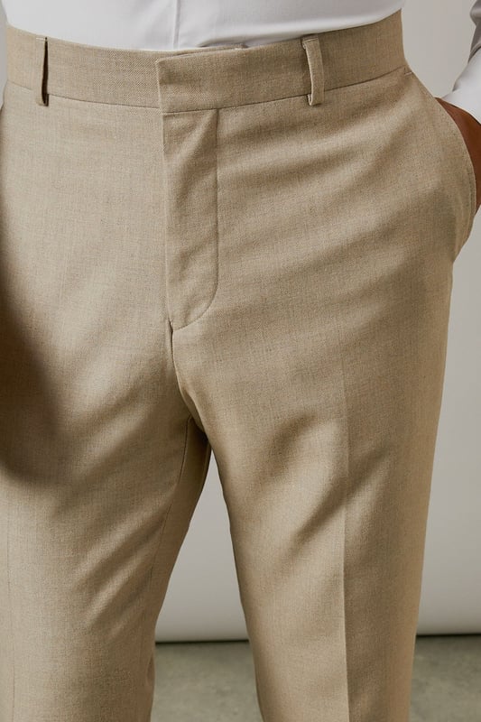 Slim fit design with a tailored silhouette that defines the leg without restricting movement
        Textured woven fabric adds subtle dimension and visual interest to your formal attire
        Classic flat front styling for a clean, contemporary appearance
        Functional side pockets and button-fastened back pockets for practicality
        Versatile neutral tone that pairs effortlessly with various shirt and jacket combinations
    
    These textured slim fit trousers from Burton deliver refined style with modern sensibility. The tailored cut creates a sharp silhouette that's ideal for the gentleman who appreciates classic styling with contemporary proportions. Perfect for work-to-weekend versatility, pair them with the matching jacket for formal occasions or team with a crisp white shirt as shown for smart-casual events. The textured fabric adds character whilst maintaining a sophisticated appearance that works brilliantly for important meetings or social gatherings. These trousers coordinate seamlessly with brown leather brogues and a complementary belt for a polished finish. An essential addition to any discerning wardrobe, these trousers will become your go-to choice for everything from business meetings to sophisticated evening events at your local gastropub.