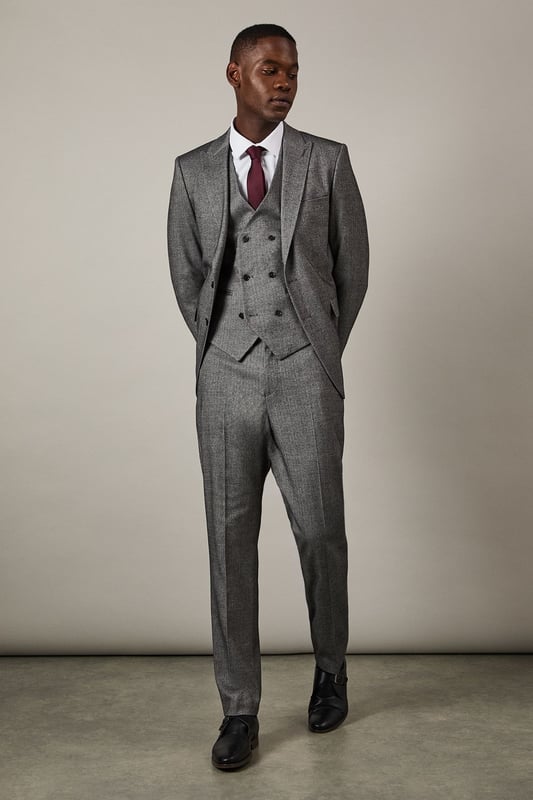 Distinctive herringbone pattern adds subtle texture and visual interest
        Slim fit design offers a contemporary silhouette that flatters the modern man
        Flat front styling creates a clean, streamlined appearance
        Back pockets with button closure for secure storage
        Versatile trousers that pair perfectly with matching suit pieces or as separates
    
    These Burton herringbone trousers present the perfect balance of classic tailoring and contemporary style. The slim fit contours to your frame without restricting movement, making them ideal for the gentleman who appreciates refined clothing with practical comfort. Style them as shown with a crisp white shirt for formal occasions, or dress them down with a lightweight jumper for smart-casual events. The versatile design transitions seamlessly from important business meetings to after-work drinks at the pub. Complete the look with polished Oxford shoes for traditional sophistication, or pair with smart Chelsea boots for a modern twist. These trousers serve as a cornerstone piece in any well-curated wardrobe, offering endless styling possibilities throughout the seasons.