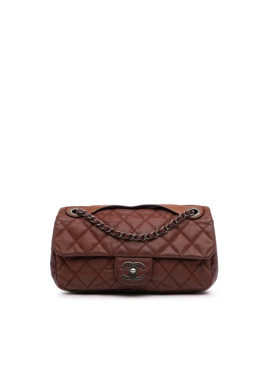 This satchel features a quilted lambskin leather body a flat leather top handle a leather woven chain link strap a front flap with CC turn lock closure and an interior zip pocket.Brand: ChanelCondition: Pre-lovedType: SatchelRating: B+Main Material: LeatherDimensions (LxWxD): 15x26.5x8Strap Drop: 28.5Comments: Lock Scratched. Exterior Handle Worn. Interior Lining stained with Other. Practical Attachment Scratched. Exterior Side Cracked Worn. Item has an odor of Other.
