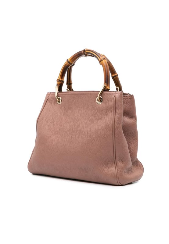 The Bamboo Shopper features a leather body bamboo top handles a detachable and adjustable flat leather shoulder strap an open top with magnetic snap closure and interior zip and slip pockets.Brand: GucciCondition: Pre-lovedType: SatchelRating: B+Main Material: LeatherDimensions (LxWxD): 25x28x10Strap Drop: 50Handle Drop: 11Comments: Exterior Back Worn. Exterior Bottom Worn. Lock Scratched. Exterior Corners Worn. Embellishment Scratched. Exterior Front Worn. Exterior Front stained with Pen Mark. Exterior Handle Worn. Interior Pocket Worn. Interior Lining Worn. Practical Attachment Scratched. Exterior Side Worn. Exterior Top Worn. Zipper Scratched.