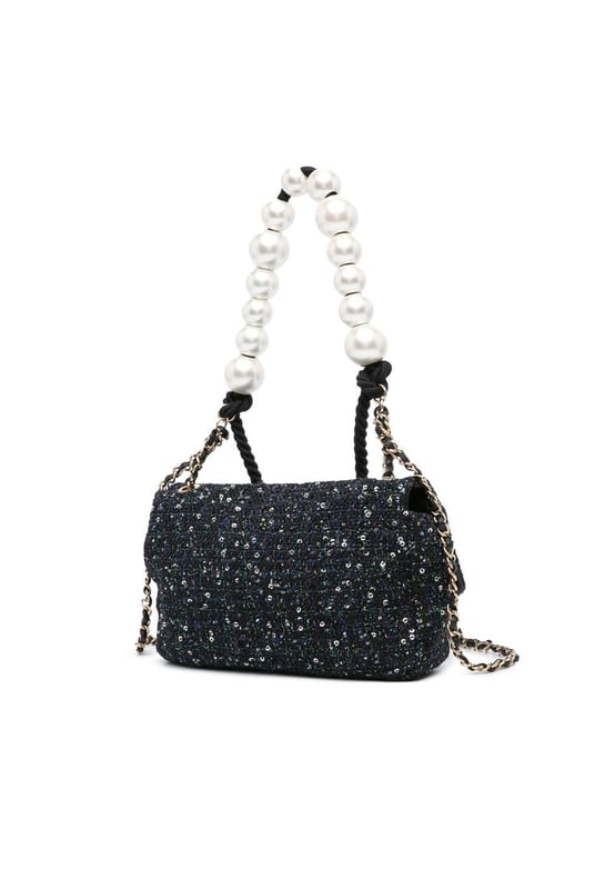 This flap bag features a tweed body with sequin details a faux pearl handle a leather woven chain shoulder strap with leather guard a front flap with interlocking Cs and twist lock closure and an interior zip pocket.Brand: ChanelCondition: Pre-lovedType: SatchelRating: B+Main Material: fabricDimensions (LxWxD): 16x23x7Strap Drop: 52Handle Drop: 20Comments: Exterior Back Creased Worn. Exterior Bottom Worn. Lock Scratched. Exterior Corners Worn. Embellishment Scratched. Exterior Front Loose Stitching Worn. Exterior Handle Worn. Interior Pocket Worn. Interior Lining Scratched Worn. Practical Attachment Scratched. Exterior Side Worn. Exterior Top Worn. Zipper Scratched.