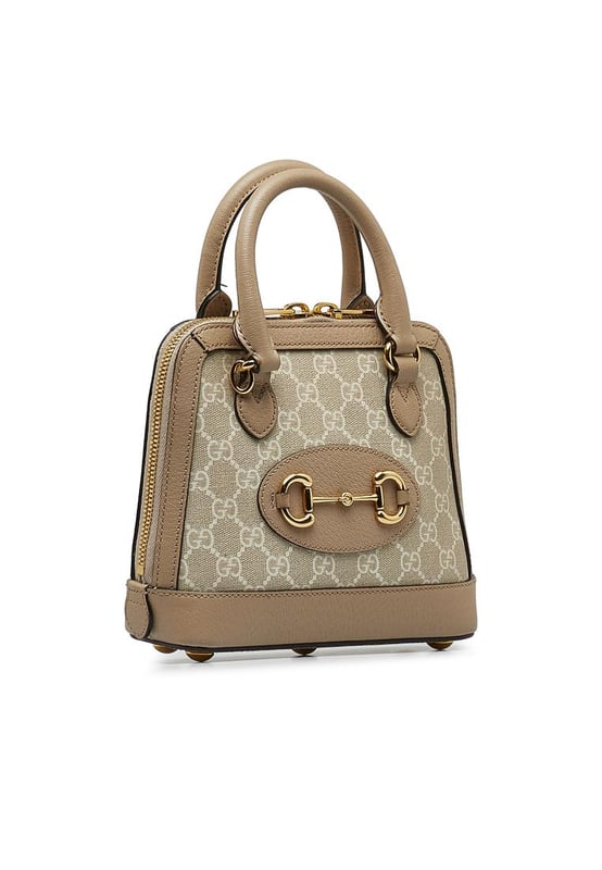 The Horsebit 1955 satchel features a coated canvas body with leather trim rolled leather handles a zip-around closure and interior zip and slip pockets.Brand: GucciCondition: Pre-lovedType: SatchelRating: B+Main Material: FabricDimensions (LxWxD): 17.5x20x7Handle Drop: 8.5Comments: Exterior Back Out Of Shape. Exterior Bottom Out Of Shape. Exterior Corners Worn. Exterior Front Discolored Out Of Shape. Exterior Front stained with Other. Exterior Handle Discolored Out Of Shape Scratched Worn. Interior Pocket stained with Pen Mark Other. Interior Lining Worn. Interior Lining stained with Other. Practical Attachment Scratched. Exterior Side Out Of Shape. Exterior Top Out Of Shape Scratched. Zipper Scratched.