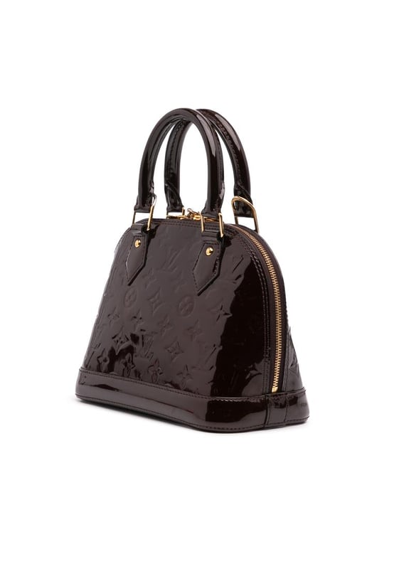 The Alma BB features a monogram vernis leather body a clochette rolled leather handles a top zip-around closure and an interior slip pocket.Brand: Louis VuittonCondition: Pre-lovedType: SatchelRating: B+Main Material: LeatherDimensions (LxWxD): 17.5x23.5x11.5Strap Drop: 56.5Handle Drop: 10.5Comments: Exterior Bottom Scratched. Exterior Handle Scratched. Interior Lining stained with Other. Practical Attachment Scratched. Exterior Top stained with Other. Zipper Scratched.