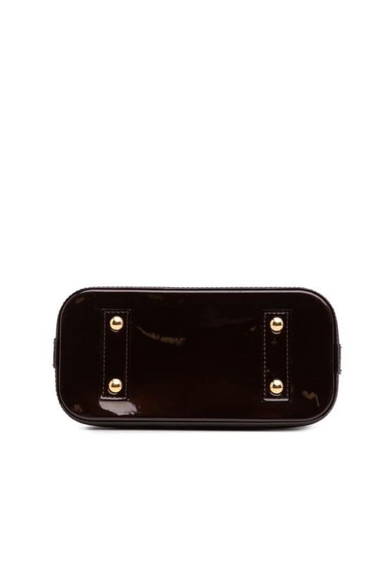 The Alma BB features a monogram vernis leather body a clochette rolled leather handles a top zip-around closure and an interior slip pocket.Brand: Louis VuittonCondition: Pre-lovedType: SatchelRating: B+Main Material: LeatherDimensions (LxWxD): 17.5x23.5x11.5Strap Drop: 56.5Handle Drop: 10.5Comments: Exterior Bottom Scratched. Exterior Handle Scratched. Interior Lining stained with Other. Practical Attachment Scratched. Exterior Top stained with Other. Zipper Scratched.