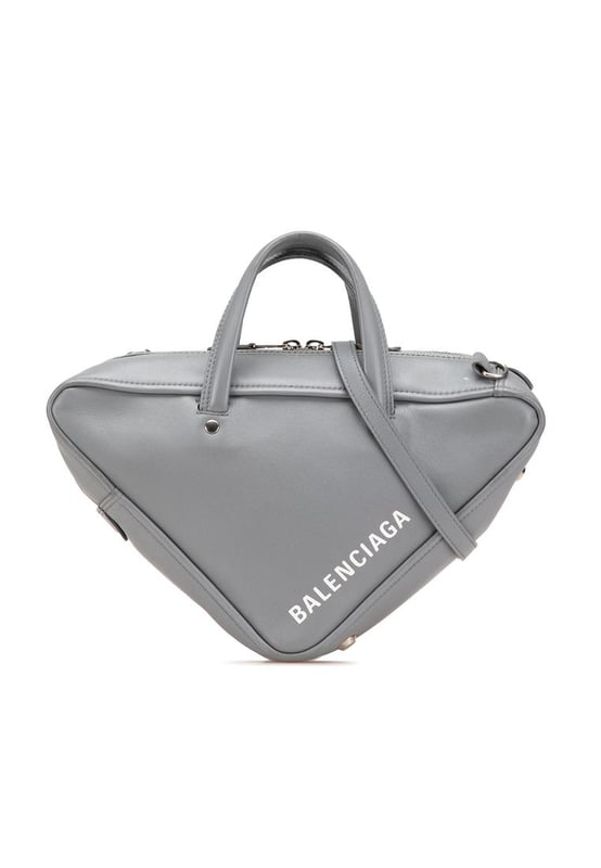 The Triangle Duffle bag features a leather body flat leather handles a detachable flat leather strap a top zip closure and an interior zip pocket.Brand: BalenciagaCondition: Pre-lovedType: SatchelRating: B+Main Material: LeatherDimensions (LxWxD): 15x35x8Strap Drop: 61Handle Drop: 9.5Comments: Exterior Back Worn. Exterior Bottom Out Of Shape Worn. Exterior Front Worn. Interior Pocket stained with Other. Interior Lining Scratched. Practical Attachment Scratched. Exterior Side Out Of Shape Worn. Exterior Top Out Of Shape Worn. Exterior Top stained with Other. Zipper Scratched.