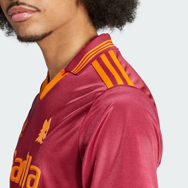 Relive a slice of AS Roma history in this adidas jersey. A faithful recreation of the club's 92/93 shirt, it shows off a simplified badge and flock-printed Trefoil. Whether you're cheering on the Giallorossi at the Stadio Olimpico or showing your club spirit around town, its relaxed fit will keep you comfortable in quintessential '90s football style.This product is made with 100% recycled materials. By reusing materials that have already been created, adidas help to reduce waste and our reliance on finite resources and reduce the footprint of the products adidas make.  - Loose fit - V-neck - 100% polyester (recycled) - AS Roma embroidered crest  Shipped by adidas