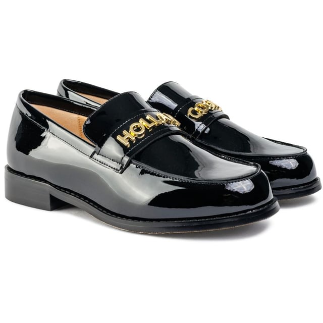 A statement piece crafted from premium high-shine patent leather. This sophisticated loafer by Holland Cooper is adorned with iconic gold hardware over the toe for a distinctive and luxurious touch. Perfect for elevating any outfit, the Abbot Loafer seamlessly blends timeless design with bold branding, making it a must-have addition to your footwear collection.