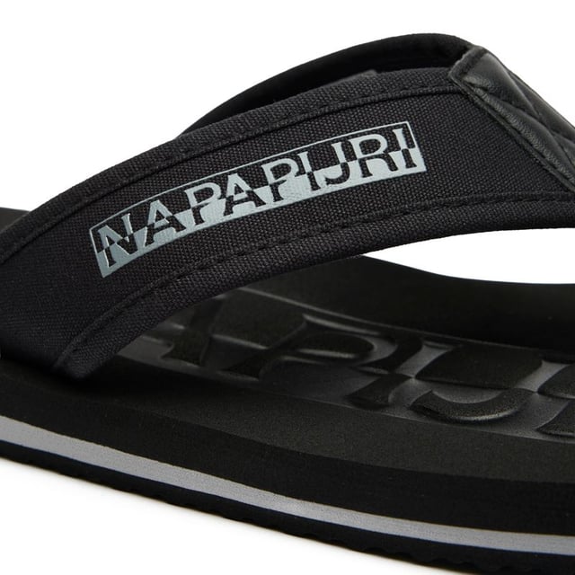 The Napapijri Elm delivers effortless summer style in sleek black. These contemporary flip flops combine durability with comfort, featuring reinforced nylon upper straps that withstand beach-to-bar transitions. The microporous EVA sole provides exceptional cushioning for all-day wear, while maintaining a lightweight feel. Perfect for casual outings or poolside lounging, these sandals embody Napapijri's signature blend of practical design and understated elegance. An essential addition to your warm-weather wardrobe.