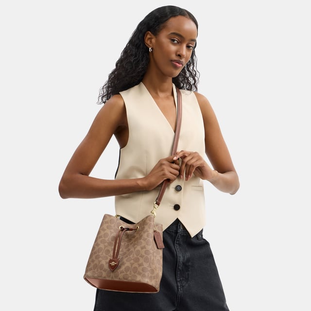 Rowan Bucket Bag in Signature Canvas, Removable zip pouch
 Center open compartment,  Length: 21.50 cm,  Width: 14.00 cm,  Height: 21.50 cm