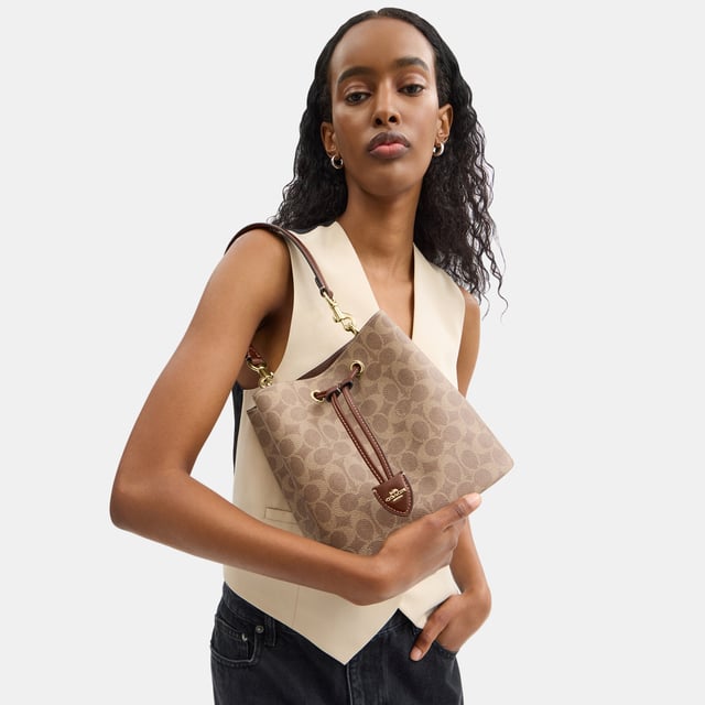 Rowan Bucket Bag in Signature Canvas, Removable zip pouch
 Center open compartment,  Length: 21.50 cm,  Width: 14.00 cm,  Height: 21.50 cm