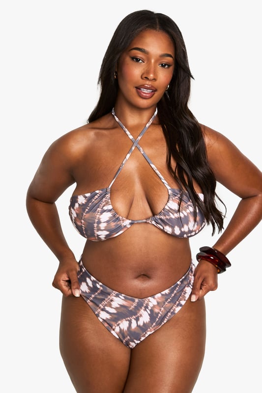 Striking batik print bikini bottoms designed with a flattering V-shaped waistband
        High-cut leg design to elongate your silhouette
        Comfortable stretch fabric ensures the perfect fit for all-day wear
        Pairs perfectly with the matching halterneck bikini top
        Designed specifically for plus sizes with inclusive fit considerations
    
    Make a statement poolside with these eye-catching batik print bikini bottoms from Boohoo. The distinctive V-shaped waistband creates a flattering silhouette that complements your curves, while the high-cut leg design adds a touch of retro glamour. Style with the coordinating halterneck top for a complete look that radiates confidence. These bottoms are perfect for casual beach days, pool parties, or simply lounging in the garden with friends. Add oversized sunglasses and a lightweight kimono for trips to the beach bar, or pair with a floaty sarong when strolling along the promenade. The stretchy fabric moves with you, ensuring comfort whether you're taking a dip or soaking up the sun. Ideal for your next holiday or staycation, these bikini bottoms will quickly become your go-to swimwear essential.