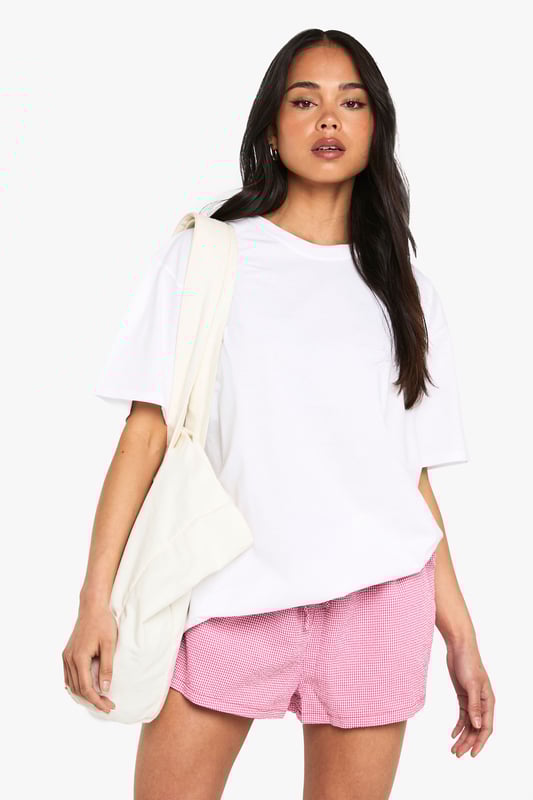 Oversized fit for ultimate comfort and relaxed styling
        Bold back graphic print makes a statement
        Short sleeves with dropped shoulders for a contemporary silhouette
        Crafted from soft cotton for breathable all-day wear
        Versatile round neckline suits various styling options
    
    Make a cheeky statement in this eye-catching oversized tee from Boohoo. The relaxed silhouette creates an effortlessly cool vibe that's perfect for casual outings. Style it with shorts as shown for warm-weather adventures, or pair with your favourite denim and trainers for an everyday look. For a touch of edge, try a half-tuck into high-waisted jeans with chunky boots. This versatile piece transitions seamlessly from daytime coffee runs to casual meet-ups with mates. Layer under a denim jacket when the temperature drops or throw on with cycling shorts for an on-trend athleisure ensemble. The playful back graphic adds personality to even the simplest outfit combinations, making this tee a standout addition to your casual wardrobe.