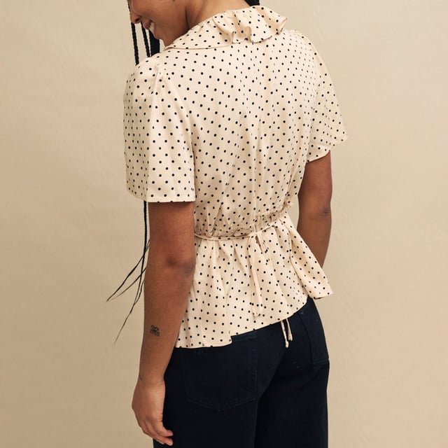 Women's Nobodys Child Joely Blouse. Every wardrobe needs a cute top like Joley. Woven entirely from responsible viscose, she’ll infuse a little vintage-inspired romance into your look with her fluted sleeves and floaty ruffles. We love the cream polka dot print and the figure-skimming fit. Style yours with black jeans.- V-neck.- Fluted sleeves.- Under bust seams designed to flatter.- String tie detail. Material: 100% Ecovero™ Viscose. Ref: T240662CRM.