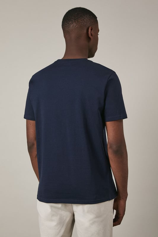 Crafted from soft cotton jersey for all-day comfort
        Features a distinctive sailing crest graphic print in contrasting hues
        Classic crew neck design with short sleeves for a timeless silhouette
        Straight hem with clean finishing for a polished appearance
        Part of the Maine collection, reflecting nautical heritage and style
    
    This Maine Sailing Crest Print T-shirt combines casual comfort with maritime charm. The striking quadrant design showcases nautical motifs including a sailing boat and crest emblem, perfect for adding character to your weekend wardrobe. Style as seen on our model with light-coloured shorts and crisp white trainers for an effortless summer look that works brilliantly for coastal walks or casual gatherings. For cooler evenings, layer under a lightweight bomber jacket or unstructured blazer. The versatile design transitions seamlessly from daytime outings to relaxed evening socials, making it an essential addition to your casual collection. Machine washable at 30 degrees, this t-shirt maintains its shape and graphic detail with proper care.