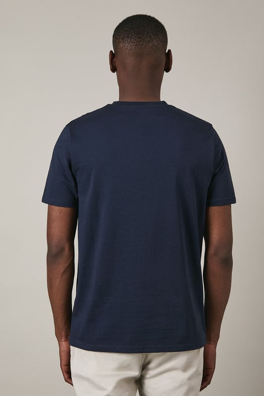 Soft jersey fabric for all-day comfort and breathability
        Classic crew neckline with ribbed trim for a neat finish
        Distinctive coastal ship emblem on chest for nautical appeal
        Short sleeves with clean-cut edges for a streamlined look
        Relaxed fit through the body offering ease of movement
    
    This Maine coastal print t-shirt brings maritime charm to your casual wardrobe. The understated design features a distinctive sailing ship emblem encircled by a laurel wreath, creating a subtle focal point against the navy background. Style it as shown with light-coloured shorts and white trainers for a fresh summer look perfect for beachside strolls or weekend brunches. For cooler evenings, layer under an unstructured blazer or light cotton overshirt. The versatile design transitions effortlessly from daytime casual to relaxed evening gatherings. The cotton jersey construction ensures this t-shirt remains comfortable throughout the day, making it an ideal choice for family outings, casual meet-ups with friends, or simply lounging at home with understated style.