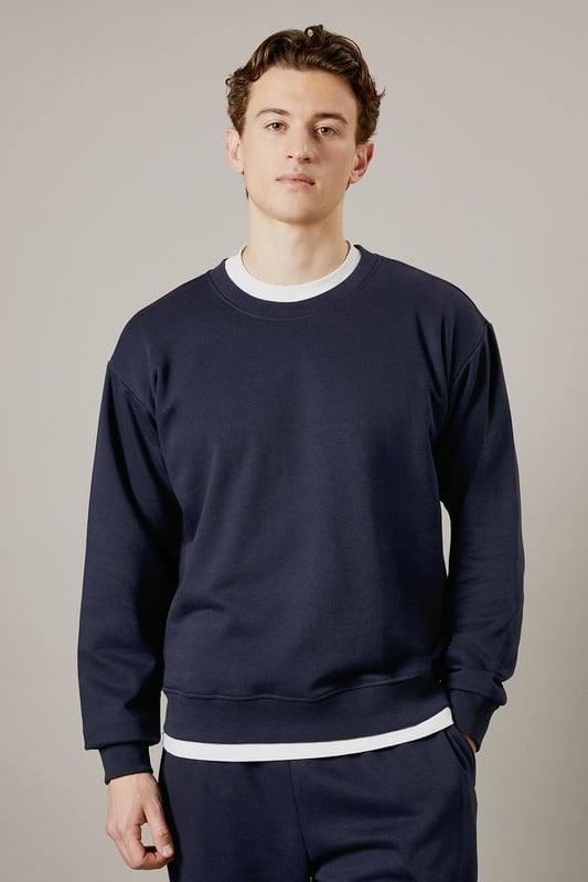 Classic crew neck design with ribbed collar for a comfortable fit
        Soft jersey fabric provides warmth without bulk
        Ribbed cuffs and hem maintain shape throughout wear
        Relaxed silhouette offers ease of movement for everyday activities
        Versatile layering piece that works across seasons
    
    This Burton crew neck sweatshirt delivers timeless casual style with practical comfort. The clean, unfussy design makes it a wardrobe essential that pairs effortlessly with your existing collection. Layer it over a simple white t-shirt as shown for a classic look, or wear it solo when temperatures rise. Perfect for weekend sports matches, casual pub gatherings with mates, or relaxed family occasions. The straightforward styling works brilliantly with matching joggers for a coordinated athleisure look, or team with your favourite jeans and trainers for everyday wear. For cooler days, it slides easily under a gilet or jacket without adding unnecessary bulk. Machine washable and durable, this sweatshirt offers the reliable performance you need from your casual wardrobe staples.