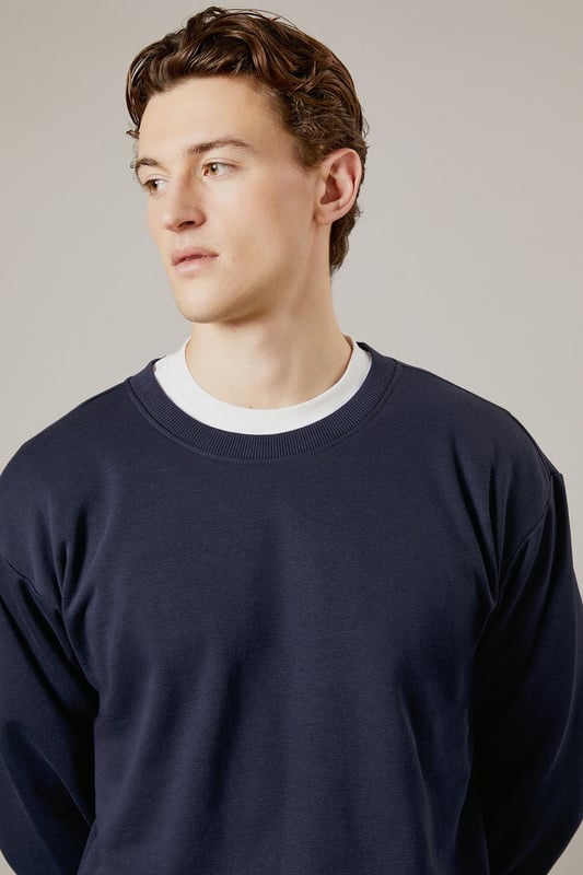 Classic crew neck design with ribbed collar for a comfortable fit
        Soft jersey fabric provides warmth without bulk
        Ribbed cuffs and hem maintain shape throughout wear
        Relaxed silhouette offers ease of movement for everyday activities
        Versatile layering piece that works across seasons
    
    This Burton crew neck sweatshirt delivers timeless casual style with practical comfort. The clean, unfussy design makes it a wardrobe essential that pairs effortlessly with your existing collection. Layer it over a simple white t-shirt as shown for a classic look, or wear it solo when temperatures rise. Perfect for weekend sports matches, casual pub gatherings with mates, or relaxed family occasions. The straightforward styling works brilliantly with matching joggers for a coordinated athleisure look, or team with your favourite jeans and trainers for everyday wear. For cooler days, it slides easily under a gilet or jacket without adding unnecessary bulk. Machine washable and durable, this sweatshirt offers the reliable performance you need from your casual wardrobe staples.