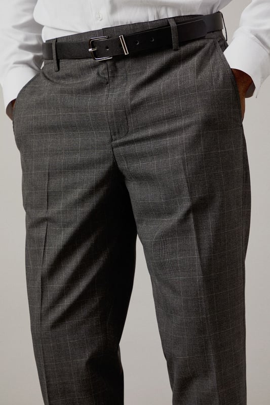 Classic Prince of Wales check pattern adds sophisticated visual interest
        Slim fit design offers a modern, streamlined silhouette
        Clean front styling with side pockets for practicality
        Back pockets with button closure for secure storage
        Versatile charcoal tone perfect for year-round wear
    
    These Burton slim fit trousers showcase timeless British tailoring with a contemporary edge. The distinctive Prince of Wales check pattern presents a refined aesthetic that works brilliantly for smart occasions whilst maintaining versatility. Style them as seen with a crisp white shirt and polished black leather shoes for business meetings or important presentations. For smart-casual events, pair with a fine merino wool jumper and Chelsea boots. The slim cut through the seat and thigh creates a sharp silhouette without sacrificing comfort, making these trousers ideal for long days at the office or evening gatherings at upmarket venues. Perfect for the man who appreciates classic style with modern proportions, these trousers will become a cornerstone of your smart wardrobe, transitioning effortlessly from boardroom to bar.