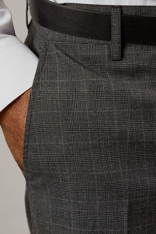 Classic Prince of Wales check pattern adds sophisticated visual interest
        Slim fit design offers a modern, streamlined silhouette
        Clean front styling with side pockets for practicality
        Back pockets with button closure for secure storage
        Versatile charcoal tone perfect for year-round wear
    
    These Burton slim fit trousers showcase timeless British tailoring with a contemporary edge. The distinctive Prince of Wales check pattern presents a refined aesthetic that works brilliantly for smart occasions whilst maintaining versatility. Style them as seen with a crisp white shirt and polished black leather shoes for business meetings or important presentations. For smart-casual events, pair with a fine merino wool jumper and Chelsea boots. The slim cut through the seat and thigh creates a sharp silhouette without sacrificing comfort, making these trousers ideal for long days at the office or evening gatherings at upmarket venues. Perfect for the man who appreciates classic style with modern proportions, these trousers will become a cornerstone of your smart wardrobe, transitioning effortlessly from boardroom to bar.