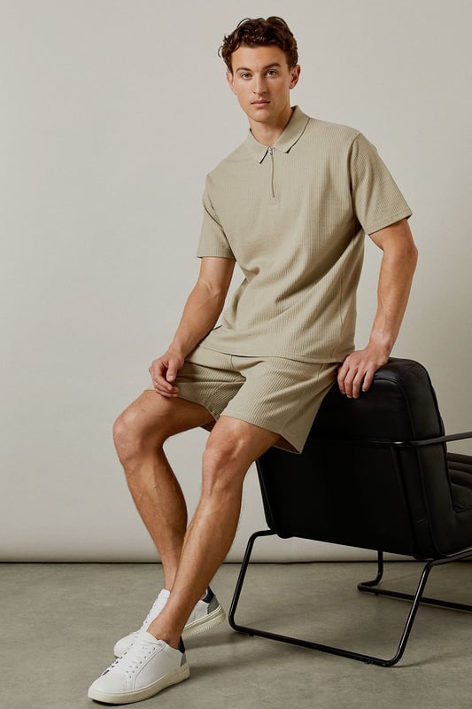 Distinctive seersucker texture adds visual interest and breathability to these casual shorts
        Comfortable elasticated waistband with adjustable drawstring for a personalised fit
        Relaxed leg shape offers ease of movement for all-day comfort
        Mid-thigh length provides a modern silhouette that works for various body types
        Cotton-rich fabric ensures these shorts remain soft and comfortable throughout the day
    
    These Burton seersucker shorts combine classic style with modern comfort, perfect for the man who appreciates timeless fashion. The textured fabric adds subtle sophistication while remaining thoroughly practical for warm-weather wear. Style them as shown with a matching polo shirt for a coordinated look that works brilliantly for weekend barbecues or casual pub gatherings with mates. Alternatively, pair with a crisp white t-shirt and trainers for an effortless daytime ensemble. The neutral tone makes these shorts incredibly versatile, allowing them to complement your existing wardrobe with ease. They're ideal for family gatherings, sporting events, or simply relaxing in the garden on sunny afternoons. Machine washable at 30 degrees, these shorts offer both style and practicality for the modern British man.