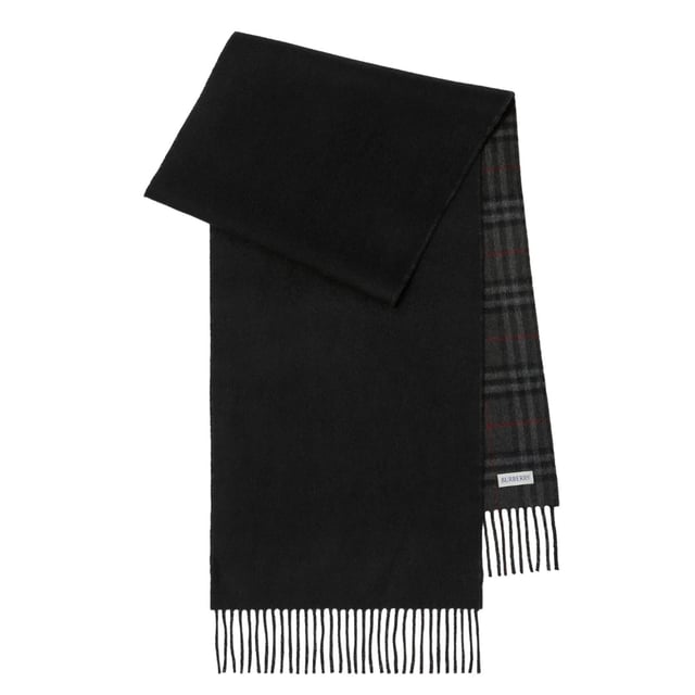 Wrap yourself in luxury with our Burberry checked Reversible Black Cashmere Scarf. Made with 100% cashmere, it's incredibly soft and warm, perfect for keeping you cozy on chilly days. Its timeless vintage check pattern adds a touch of sophistication to any outfit. With a generous size of 160x30cm, it can be styled in a variety of ways, making it a versatile and must-have accessory for any wardrobe. Elevate your style and stay warm with our Burberry cashmere scarf