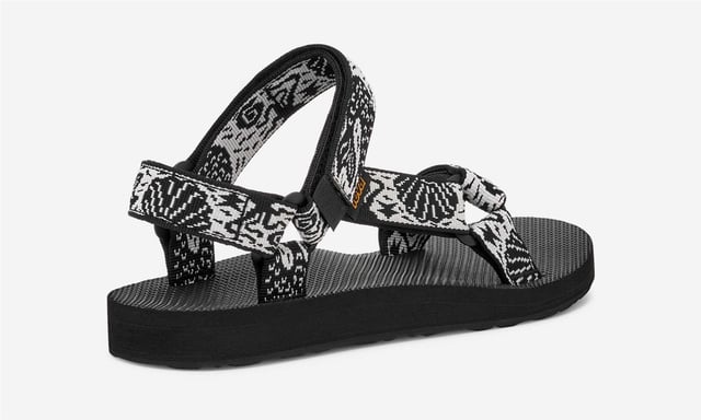 Teva Original Universal Women's Black/White Sandals Eco-friendly adventure sandals featuring the Universal Strapping System™ with multiple adjustable points for a secure fit. Crafted with quick dry webbing made from recycled REPREVE® polyester. Treated with Life Natural, a plant-based peppermint anti odour solution. Durable rubber outsole provides reliable grip for outdoor activities.