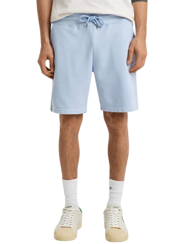 These classic sweat shorts are crafted from a soft cotton blend and tailored for a regular fit. Featuring a ribbed waistband for enhanced comfort, the design includes two front pockets, a single back pocket, and a drawstring waist. Completing the look, the shorts are adorned with a small-scale shield graphic embroidered on the left leg.