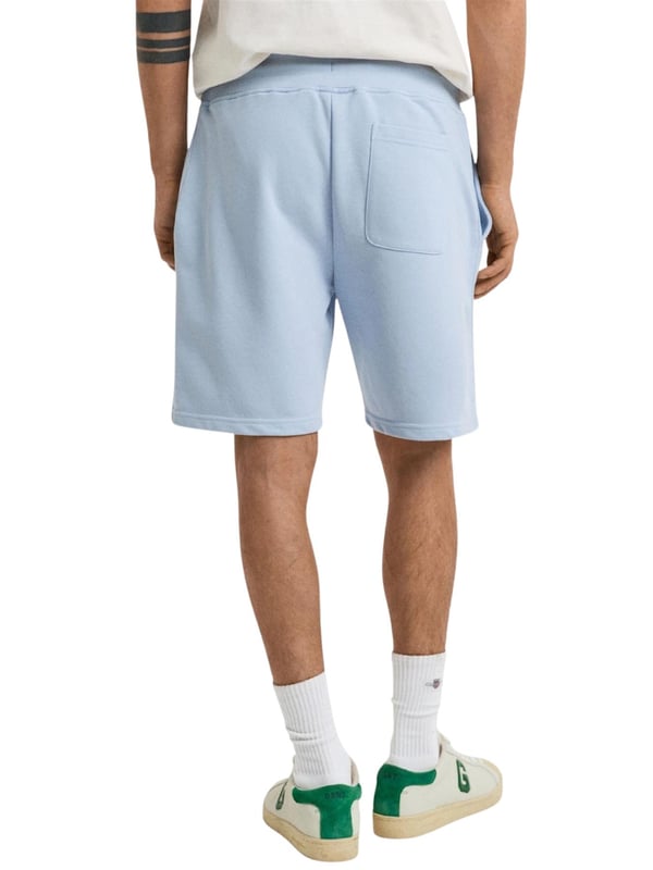 These classic sweat shorts are crafted from a soft cotton blend and tailored for a regular fit. Featuring a ribbed waistband for enhanced comfort, the design includes two front pockets, a single back pocket, and a drawstring waist. Completing the look, the shorts are adorned with a small-scale shield graphic embroidered on the left leg.