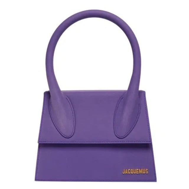 Elevate your accessory collection with the exquisite Jacquemus Le Grand Chiquito Purple Bag. This stunning designer piece combines luxurious craftsmanship with the perfect pop of vibrant purple, creating an unforgettable statement accessory. The compact yet practical size offers versatility for both day and evening wear, while the distinctive Jacquemus styling ensures you'll stand out from the crowd. A must-have investment piece that effortlessly transitions between seasons and complements any fashion-forward wardrobe. Dimensions: 18x13x7.5 cm. 100% Leather Made In Italy