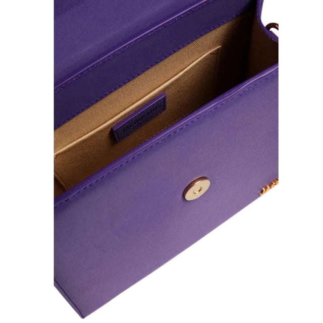 Elevate your accessory collection with the exquisite Jacquemus Le Grand Chiquito Purple Bag. This stunning designer piece combines luxurious craftsmanship with the perfect pop of vibrant purple, creating an unforgettable statement accessory. The compact yet practical size offers versatility for both day and evening wear, while the distinctive Jacquemus styling ensures you'll stand out from the crowd. A must-have investment piece that effortlessly transitions between seasons and complements any fashion-forward wardrobe. Dimensions: 18x13x7.5 cm. 100% Leather Made In Italy