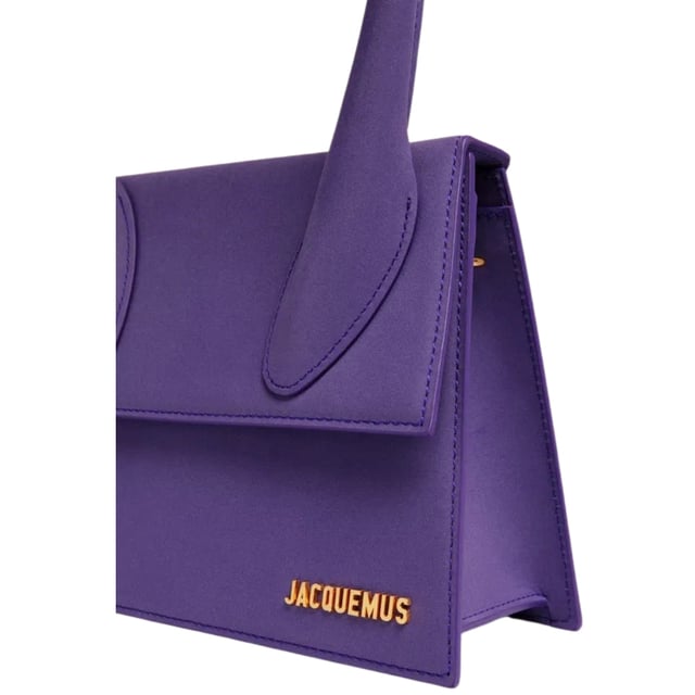 Elevate your accessory collection with the exquisite Jacquemus Le Grand Chiquito Purple Bag. This stunning designer piece combines luxurious craftsmanship with the perfect pop of vibrant purple, creating an unforgettable statement accessory. The compact yet practical size offers versatility for both day and evening wear, while the distinctive Jacquemus styling ensures you'll stand out from the crowd. A must-have investment piece that effortlessly transitions between seasons and complements any fashion-forward wardrobe. Dimensions: 18x13x7.5 cm. 100% Leather Made In Italy