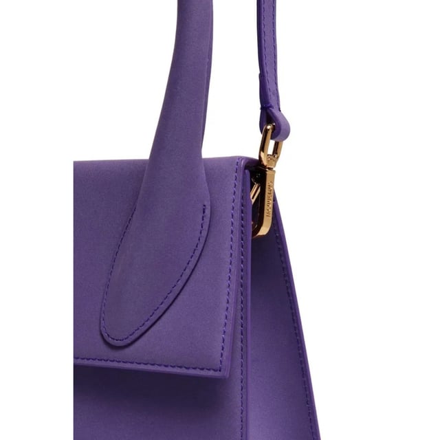 Elevate your accessory collection with the exquisite Jacquemus Le Grand Chiquito Purple Bag. This stunning designer piece combines luxurious craftsmanship with the perfect pop of vibrant purple, creating an unforgettable statement accessory. The compact yet practical size offers versatility for both day and evening wear, while the distinctive Jacquemus styling ensures you'll stand out from the crowd. A must-have investment piece that effortlessly transitions between seasons and complements any fashion-forward wardrobe. Dimensions: 18x13x7.5 cm. 100% Leather Made In Italy