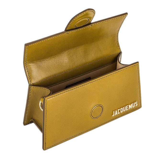 Elevate your accessory collection with the Jacquemus Le Bambino Light Khaki Green Bag. This exquisite designer piece combines understated elegance with contemporary style, featuring the signature Jacquemus minimalist aesthetic in a versatile khaki green shade. Perfect for day-to-night transitions, this compact yet statement-making bag offers both fashion-forward appeal and practical functionality. A must-have addition for the modern woman who appreciates luxury craftsmanship and distinctive design. 17.5 x 9.5 x 5.5 cm. 100% Leather Made In Italy