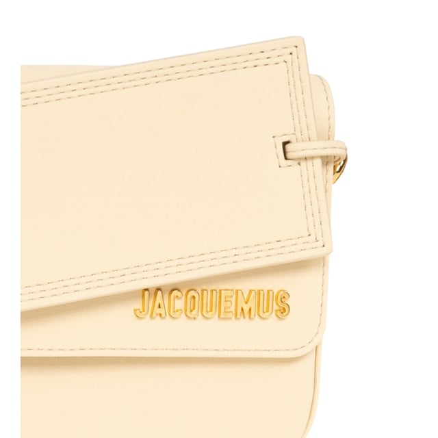 Elevate your accessory collection with the exquisite Jacquemus Le Carinu Ivory White Bag. This stunning designer piece combines timeless elegance with contemporary flair, making it the perfect statement accessory for any outfit. Crafted with meticulous attention to detail, this ivory white treasure embodies luxury and sophistication. The versatile design transitions effortlessly from day to evening, ensuring you'll stand out with refined style wherever you go. A must-have addition to any fashion-forward woman's wardrobe. Dimensions 12 x 18.5cm. 100% Leather Made In Spain
