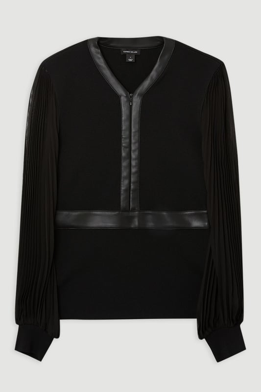 This Karen Millen top seamlessly blends sophistication with contemporary style. The knitted body offers a sleek fit, while the pleated woven sleeves add a touch of drama and movement. The faux leather trim along the V-neckline and waistband creates a striking contrast, enhancing the overall silhouette. Perfect for both day and evening wear, this top can be styled with tailored trousers and heels for a formal event, or paired with a pencil skirt for an office look. The versatility of this piece allows for endless styling possibilities, making it a valuable addition to any wardrobe. Whether you're attending a wedding, a cocktail party, or a business meeting, this top will ensure you look polished and fashion-forward.  Elegant V-neck design with faux leather trim Pleated woven sleeves for added texture Knitted body with a fitted silhouette Faux leather waistband for a defined shape Versatile piece suitable for various occasions