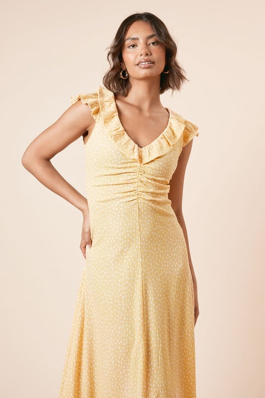 Feminine frill neckline with delicate ruffle detail for a soft, romantic touch
        Flattering ruched front design that gently contours the silhouette
        Midi length with pretty frill hem for added movement and charm
        Comfortable stretch woven fabric that moves with you throughout the day
        Versatile V-neckline that frames the dcolletage beautifully
    
    This charming spotted midi dress from Dorothy Perkins strikes the perfect balance between casual comfort and feminine style. The ruched front creates a flattering silhouette that complements all figures, whilst the frill neckline adds a touch of playfulness to your look. Style with flat sandals and a woven basket bag for weekend brunches with the girls, or dress up with espadrille wedges for garden parties and family gatherings. The midi length offers modest coverage whilst remaining thoroughly modern, making it an ideal choice for baby showers or afternoon tea. For cooler days, layer with a lightweight cardigan and pair with white trainers for an effortlessly chic ensemble. This versatile piece transitions seamlessly from daytime casual to evening drinks - simply swap your accessories to customise your look for any occasion.