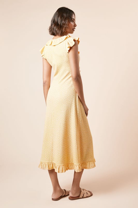 Feminine frill neckline with delicate ruffle detail for a soft, romantic touch
        Flattering ruched front design that gently contours the silhouette
        Midi length with pretty frill hem for added movement and charm
        Comfortable stretch woven fabric that moves with you throughout the day
        Versatile V-neckline that frames the dcolletage beautifully
    
    This charming spotted midi dress from Dorothy Perkins strikes the perfect balance between casual comfort and feminine style. The ruched front creates a flattering silhouette that complements all figures, whilst the frill neckline adds a touch of playfulness to your look. Style with flat sandals and a woven basket bag for weekend brunches with the girls, or dress up with espadrille wedges for garden parties and family gatherings. The midi length offers modest coverage whilst remaining thoroughly modern, making it an ideal choice for baby showers or afternoon tea. For cooler days, layer with a lightweight cardigan and pair with white trainers for an effortlessly chic ensemble. This versatile piece transitions seamlessly from daytime casual to evening drinks - simply swap your accessories to customise your look for any occasion.