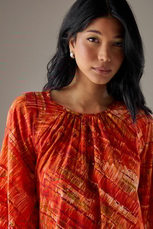 Striking trapeze silhouette creating a flowing, relaxed fit that drapes beautifully from shoulder to hem
        Voluminous balloon sleeves with gathered cuffs for a dramatic yet comfortable statement
        Round neckline with delicate gathering detail adding subtle texture and dimension
        Midi length design perfect for versatile styling across seasons
        100% cotton fabric offering breathable comfort for all-day wear
    
    This Cotton Trapeze Smock Midi Dress from Warehouse conveys effortless confidence with its bold pattern and relaxed silhouette. The generous cut creates a flattering shape that moves gracefully with your body, while the gathered neckline adds a touch of feminine detail. Style with chunky flat sandals as seen on our model for casual daytime outings, or pair with trainers and a crossbody bag for weekend market trips. For cooler weather, layer over a thin rollneck and add ankle boots for dimension. This versatile piece transitions seamlessly from family lunches to gallery visits - simply customise with your favourite jewellery to reflect your personal style. The breathable cotton construction ensures comfort throughout the day, making this dress a reliable choice for lengthy shopping excursions or informal garden gatherings.