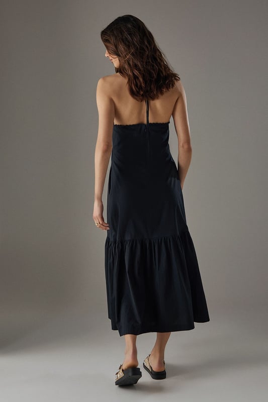 Crafted from breathable cotton poplin fabric for all-day comfort
        Delicate crochet trim detailing along the halterneck neckline adds a feminine touch
        Flattering drop waist silhouette with a relaxed midi length
        Elegant tiered hem creates movement and dimension
        Thin halter straps with back fastening for an adjustable fit
    
    This Warehouse sundress combines effortless style with practical comfort for warm-weather dressing. The relaxed drop waist silhouette creates a carefree aesthetic while the crochet trim adds a touch of artisanal detail to the halterneck design. Style with flat sandals and a woven tote for farmers' markets and weekend brunches, or dress up with espadrille wedges and statement earrings for garden parties. The versatile midi length works beautifully for coastal holidays - simply throw over your swimwear with a wide-brimmed hat for beach-to-bar ease. For cooler evenings, layer with a lightweight denim jacket and switch to ankle boots for an extended seasonal wardrobe staple that transitions seamlessly from day to night.