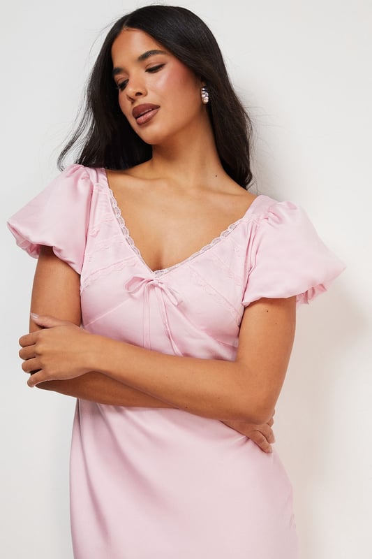 Elegant satin midi tea dress with delicate lace insert detailing
        Feminine puff sleeves with subtle volume for a romantic silhouette
        Flattering V-neckline with charming bow tie detail
        Flowing midi length design that falls gracefully to mid-calf
        Fully lined for comfort and a smooth, refined drape
    
    This enchanting Warehouse tea dress combines vintage-inspired charm with contemporary styling. The satin fabric creates a lustrous finish that catches the light beautifully, whilst the puff sleeves and lace inserts add a touch of feminine flair. Style with strappy metallic sandals as seen on our model for daytime gatherings, or dress down with white trainers and a denim jacket for weekend brunches. The versatile midi length works wonderfully for family celebrations or garden parties-simply add delicate jewellery and a woven clutch to complete the look. For cooler days, layer with a lightweight cardigan and ankle boots for an effortlessly chic ensemble that transitions seamlessly from day to evening. This dress embodies confident femininity with its subtle details and timeless silhouette.