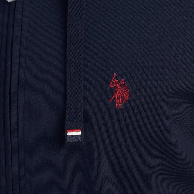 Designed for those who value functionality without sacrificing style, this US Polo Assn. zip-up hoodie combines comfort, contemporary design, and sporting heritage. Ideal for casual looks or light workouts, it adapts to the pace of everyday life with a timeless aesthetic.

 Details:
 - Full zip front closure.
 - Hood with adjustable contrasting drawstring.
 - Round neck.
 - Functional kangaroo pockets.
 - US Polo Assn. logo embroidered on the chest.
 - Soft and stretchy fabric, ideal for everyday use.
 - Ribbed cuffs and waistband.
 - Matching visible seams.

 At US Polo Assn., every garment reflects the authentic spirit of the sport of polo. This men's sweatshirt represents our commitment to quality, comfort, and classic style reinvented for the modern man.
 Composition: 100% Cotton
 Care:
Wash at maximum temperature 30º.
 Iron at low temperature.
 Do not use bleach.
 Do not use a dryer.
 Do not dry clean.