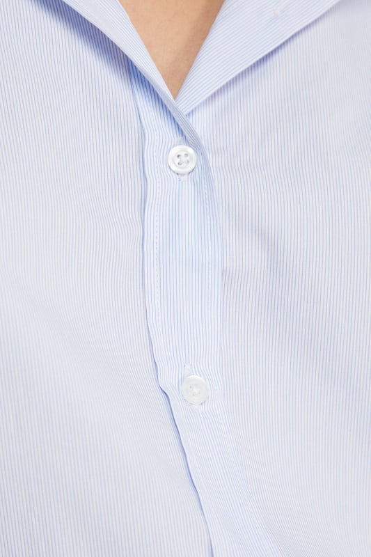 Oversized fit with classic collar and button-through front for a relaxed silhouette
        Distinctive bow-tie back detail creates a feminine twist on the traditional shirt
        Long sleeves with button cuffs offer versatility for year-round styling
        Cotton fabric provides breathable comfort for all-day wear
        Subtle split back design adds movement and contemporary flair
    
    This Warehouse oversized shirt reinvents the classic button-down with its striking bow-back detail. The relaxed fit creates an effortlessly chic look that works beautifully with straight-leg jeans and flats for casual outings. For a more polished ensemble, try half-tucking the front into high-waisted trousers and adding a structured tote. The cotton construction ensures comfort whilst maintaining a crisp appearance throughout the day. Perfect for family gatherings or weekend brunches, this versatile piece transitions seamlessly from daytime casual to evening drinks when paired with statement earrings and ankle boots. The thoughtful back detail adds interest when layered under jumpers or jackets, making this shirt a standout addition to your wardrobe that works across multiple seasons.