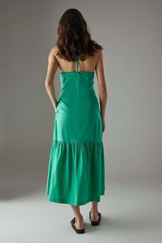 Crafted from breathable cotton poplin fabric for all-day comfort
        Delicate crochet trim detailing along the halterneck neckline adds a feminine touch
        Flattering drop waist silhouette with a relaxed midi length
        Elegant tiered hem creates movement and dimension
        Thin halter straps with back fastening for an adjustable fit
    
    This Warehouse sundress combines effortless style with practical comfort for warm-weather dressing. The relaxed drop waist silhouette creates a carefree aesthetic while the crochet trim adds a touch of artisanal detail to the halterneck design. Style with flat sandals and a woven tote for farmers' markets and weekend brunches, or dress up with espadrille wedges and statement earrings for garden parties. The versatile midi length works beautifully for coastal holidays - simply throw over your swimwear with a wide-brimmed hat for beach-to-bar ease. For cooler evenings, layer with a lightweight denim jacket and switch to ankle boots for an extended seasonal wardrobe staple that transitions seamlessly from day to night.